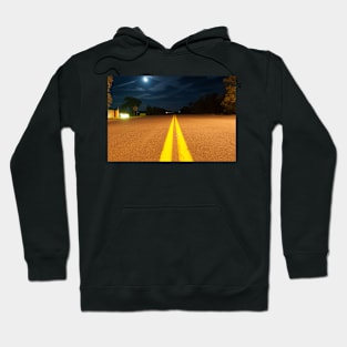 Yellow road lines stretch ahead in night light Hoodie